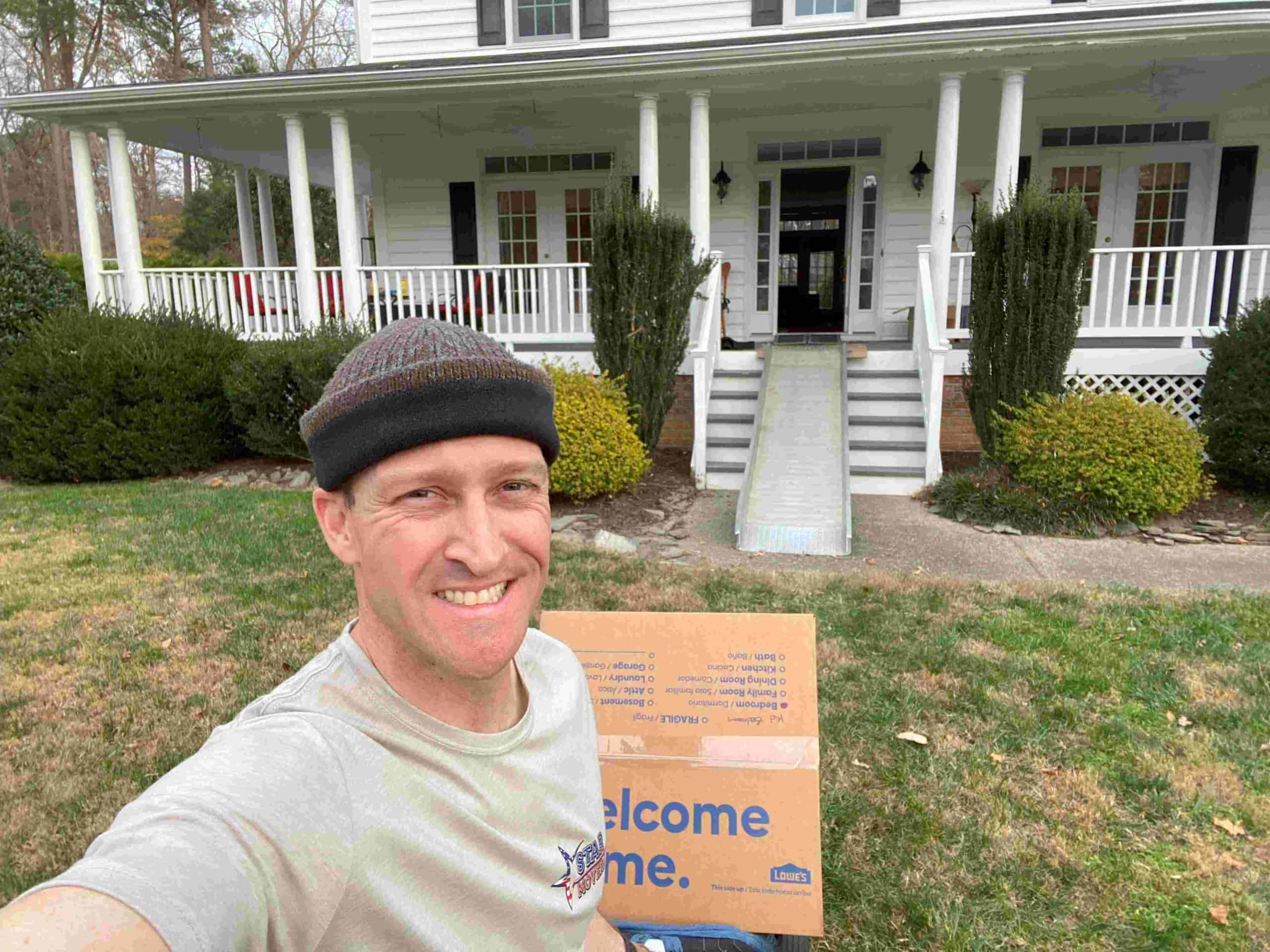 member of STAR Movers in front of a client's house