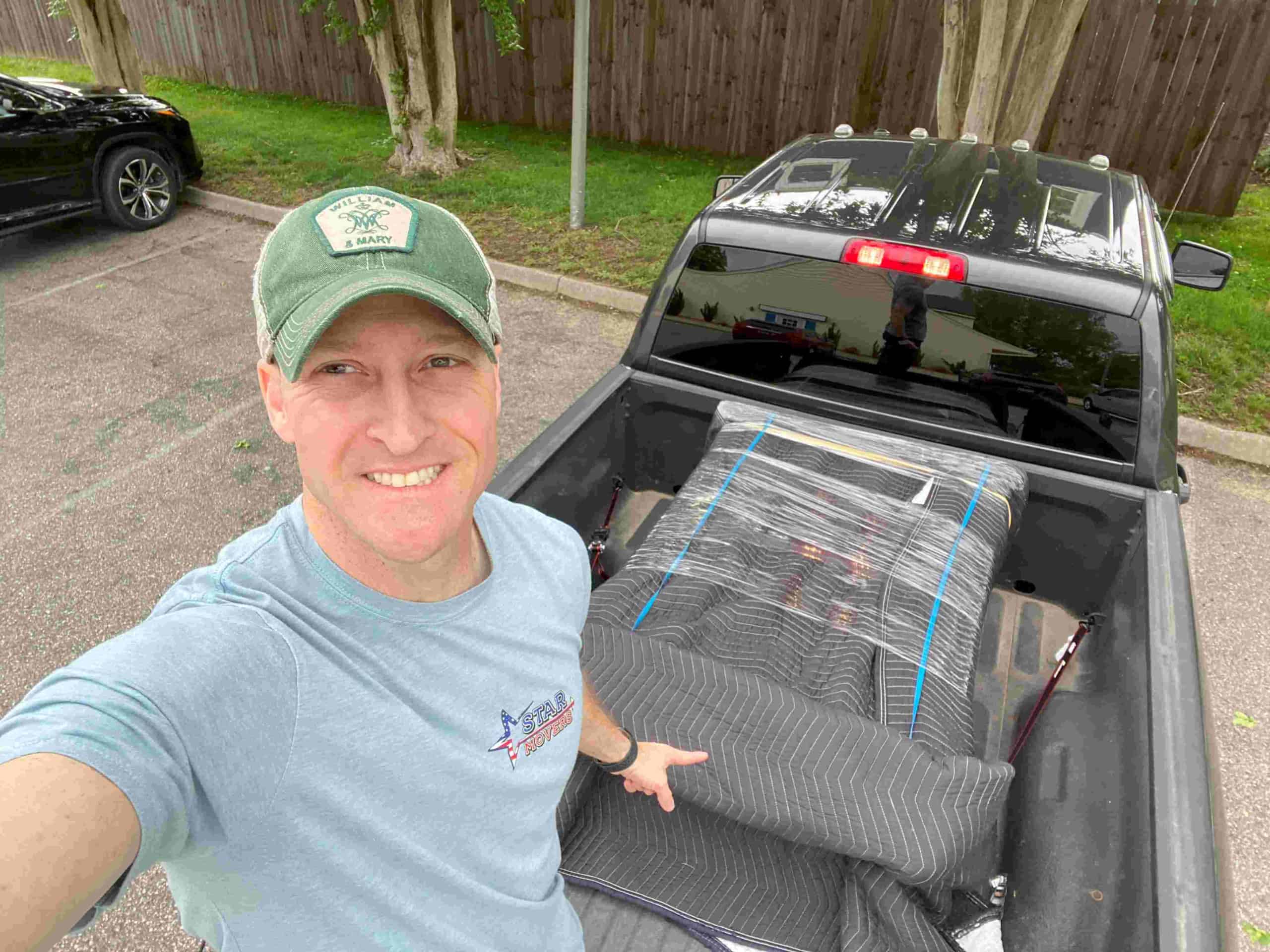 a member of STAR Movers loading items in truck